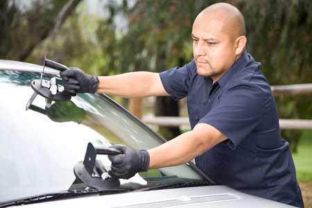 Worker replacing windshield in Houston Auto Glass Repair