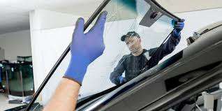 Workers fixing windshield by Houston Auto Glass Repair – Mobile Repair Services